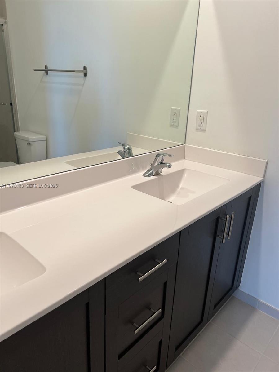20564 Northeast 5th Place Miami, FL 33179 - Photo 20 of 38 a bathroom with a sink and a mirror