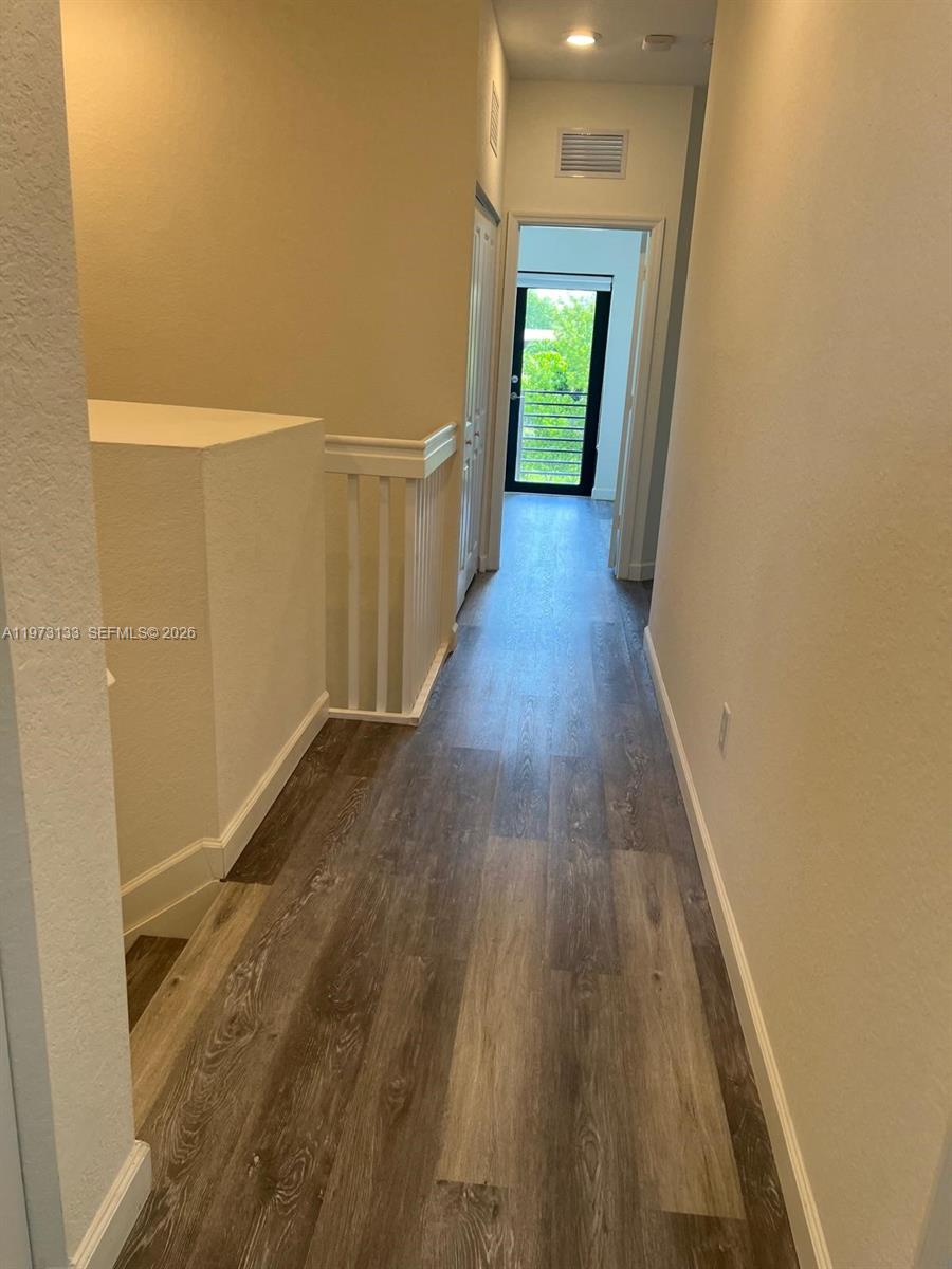 20564 Northeast 5th Place Miami, FL 33179 - Photo 22 of 38 a view of a hallway with wooden floor