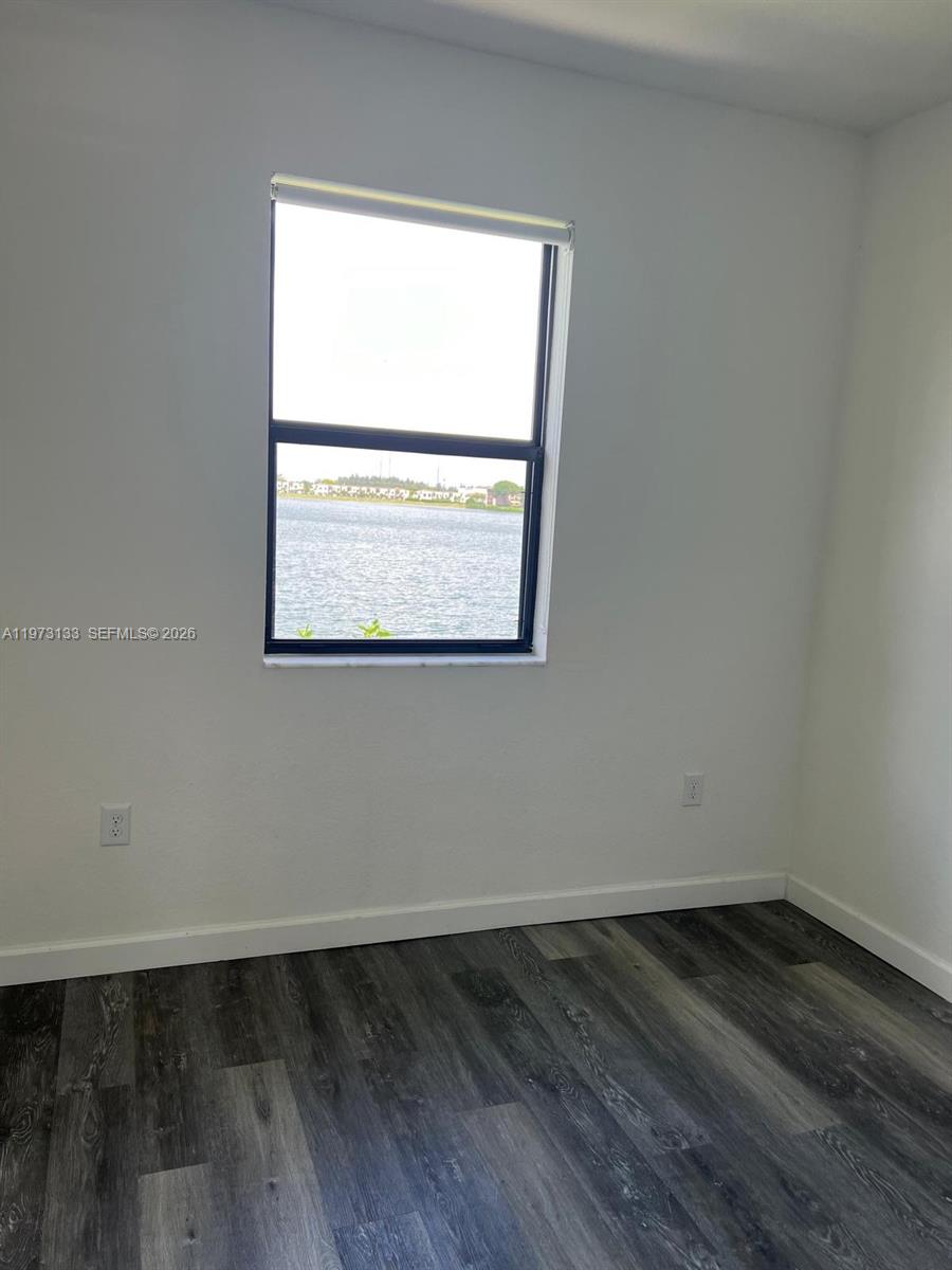 20564 Northeast 5th Place Miami, FL 33179 - Photo 23 of 38 an empty room with wooden floor and a window