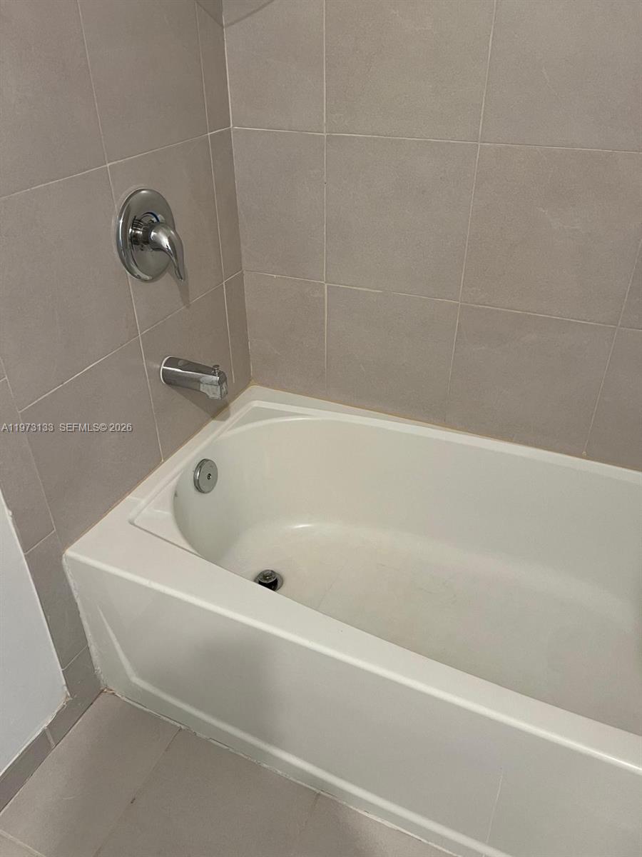 20564 Northeast 5th Place Miami, FL 33179 - Photo 26 of 38 a white bath tub sitting in a bathroom