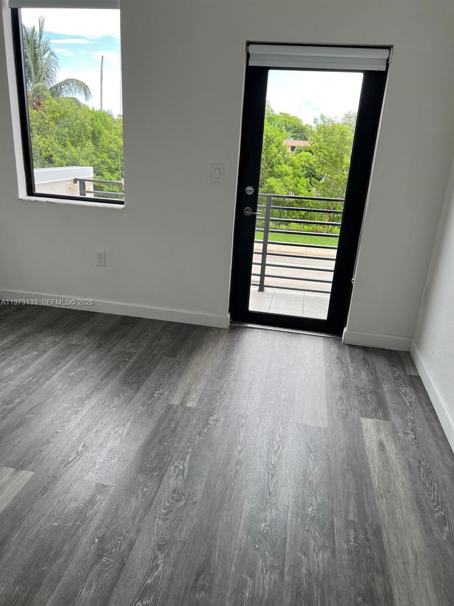 20564 Northeast 5th Place Miami, FL 33179 - Photo 33 of 38 an empty room with wooden floor and windows