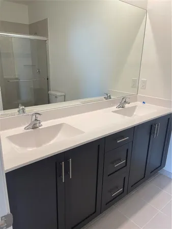 a bathroom with a double vanity sink and a mirror