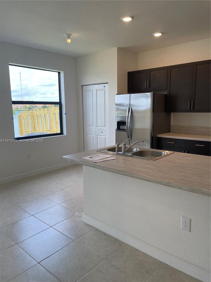 20564 Northeast 5th Place Miami, FL 33179 - Photo 6 of 38 a kitchen with stainless steel appliances a sink and a stove
