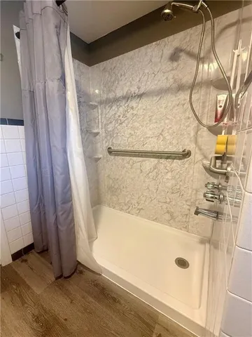 a bathroom with a sink toilet and shower