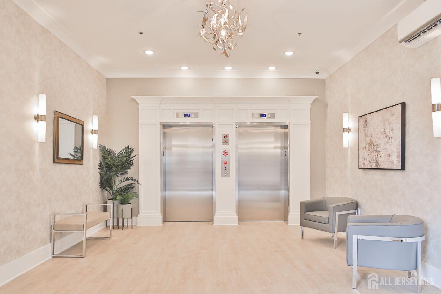 175 Quincy Court, Unit B406 Hopelawn, NJ 08861 - Photo 1 of 12 a spacious bathroom with a double vanity sink and a mirror