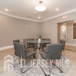 175 Quincy Court, Unit B406 Hopelawn, NJ 08861 - Photo 4 of 12 a view of a dining room with furniture