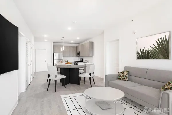a kitchen with granite countertop a stove a sink and a refrigerator