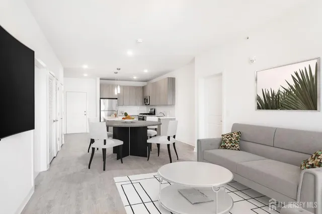 a kitchen with granite countertop a stove a sink and a refrigerator