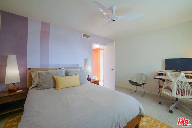 a bedroom with a bed and a chair