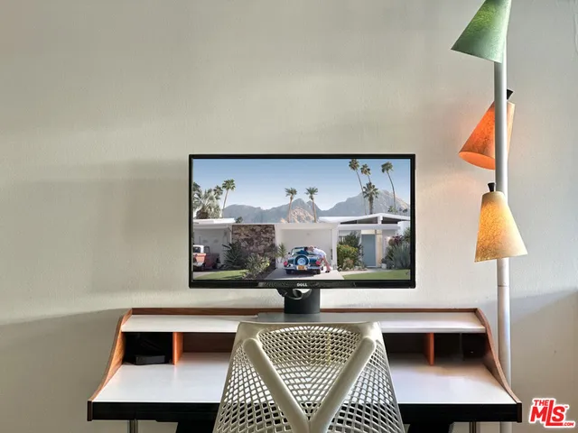 a living room with furniture and a lamp