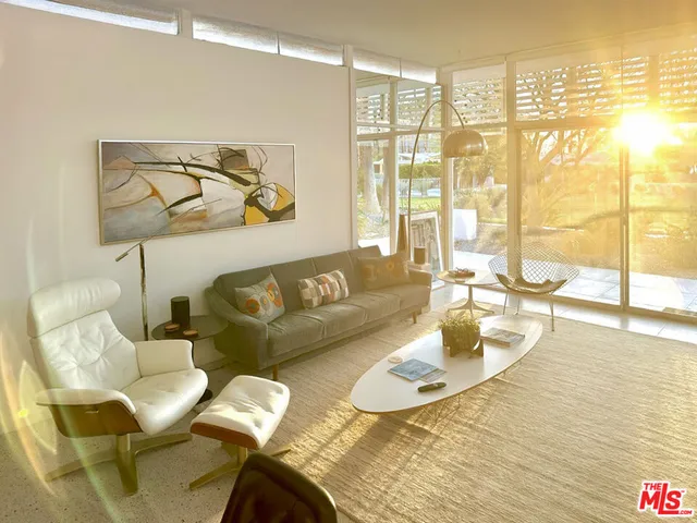 a living room with furniture and a floor to ceiling window