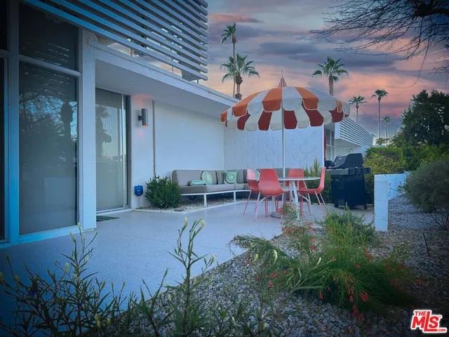 a view of a park with plants and large trees