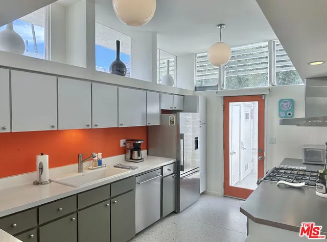 a kitchen with a sink cabinets and stainless steel appliances