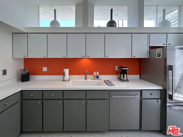 a kitchen with stainless steel appliances granite countertop a sink cabinets and granite counter tops