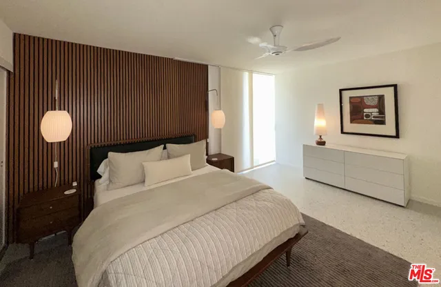 a bedroom with bed and a chandelier