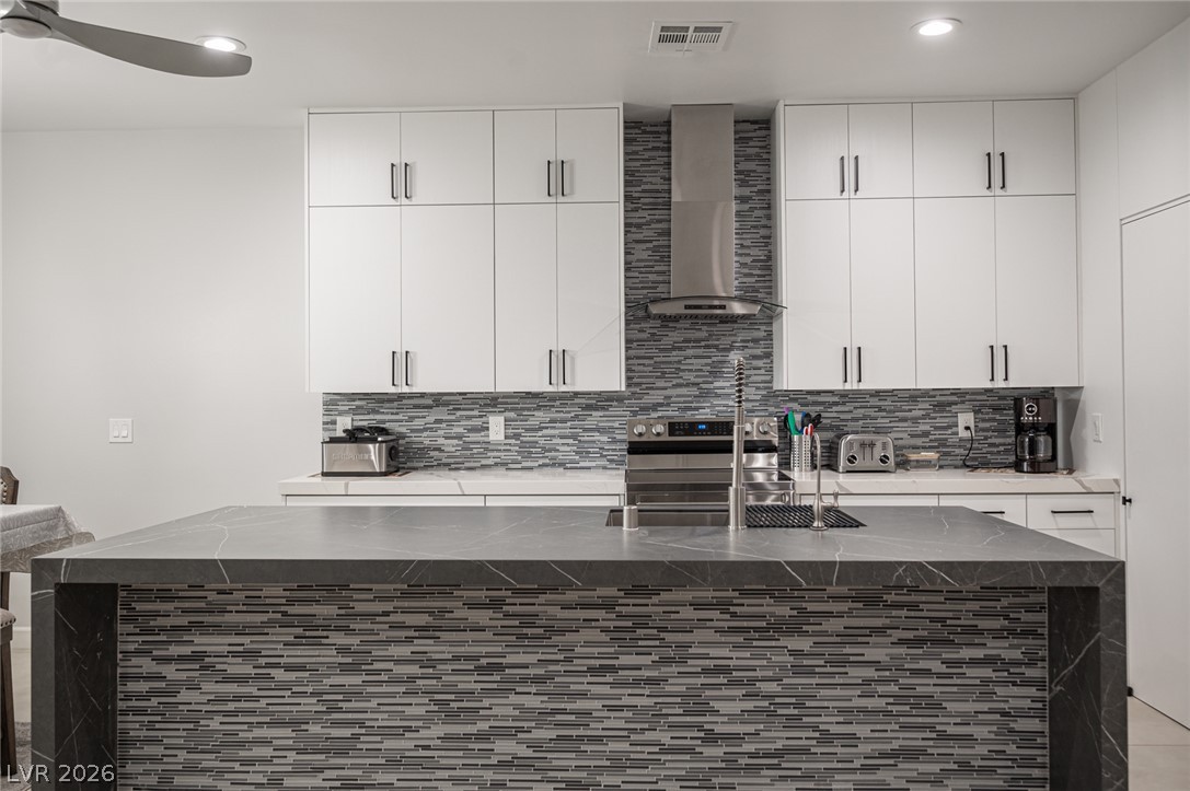 441 Belville Road Pahrump, NV 89048 - Photo 11 of 44 A well-appointed kitchen showcasing an island with sleek countertops and stylish tile work.