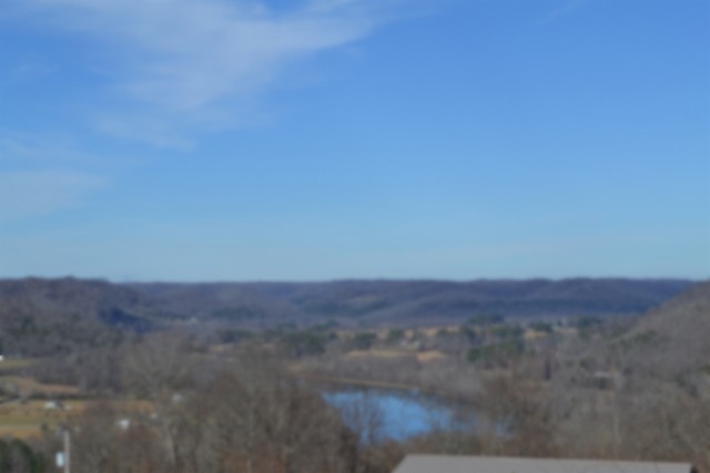 a view of city and mountain in a field