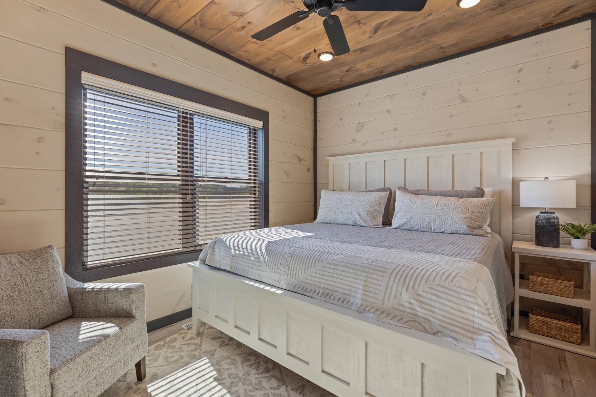 56 R Rambling Crk Way Sevierville, TN 37862 - Photo 22 of 54 a bedroom with a large bed and a chandelier