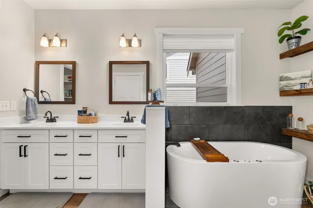 a bathroom with a bathtub a sink and a window