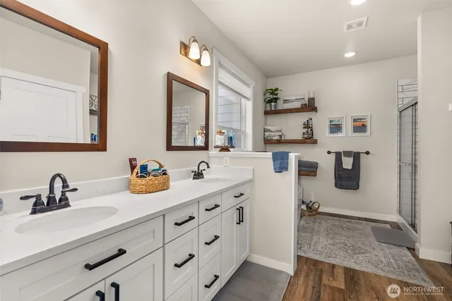 a en suite bathroom with double sink and a mirror