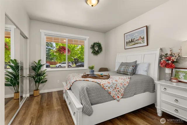 a bedroom with bed and a potted plant