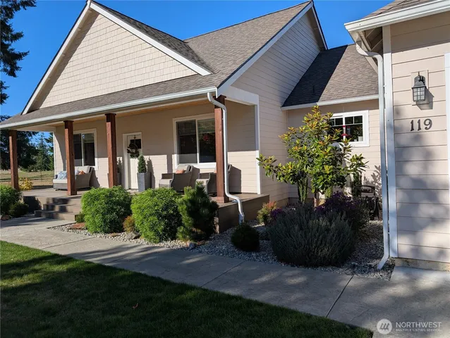a view of a house with backyard sitting area and garden