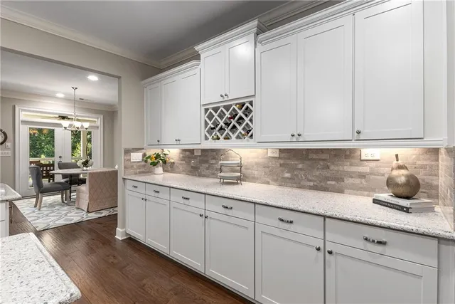 a spacious bedroom with a bed and wooden floor