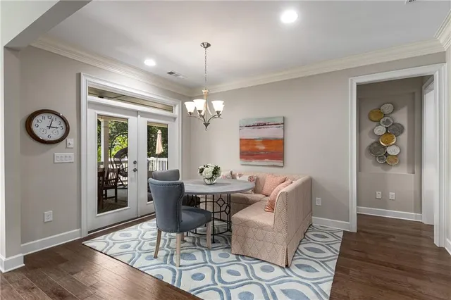 a living room with furniture pool table and kitchen view