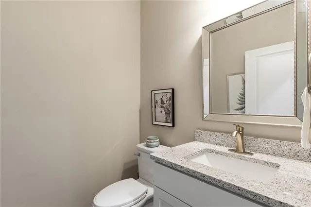 a spacious bedroom with a bed and a chair