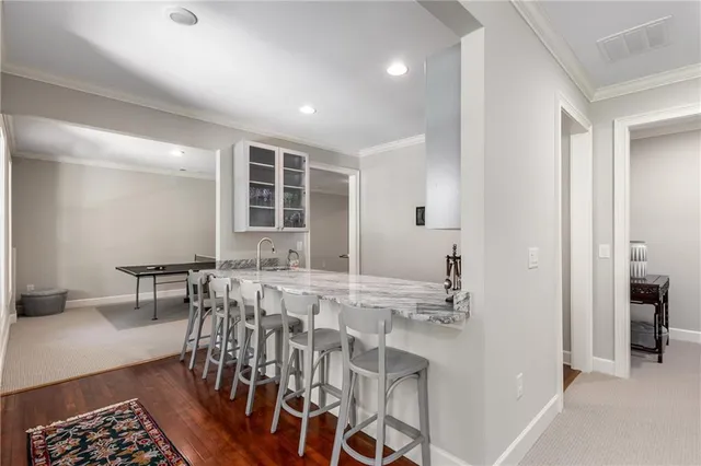an aerial view of a tennis ground and a cars park side of the road