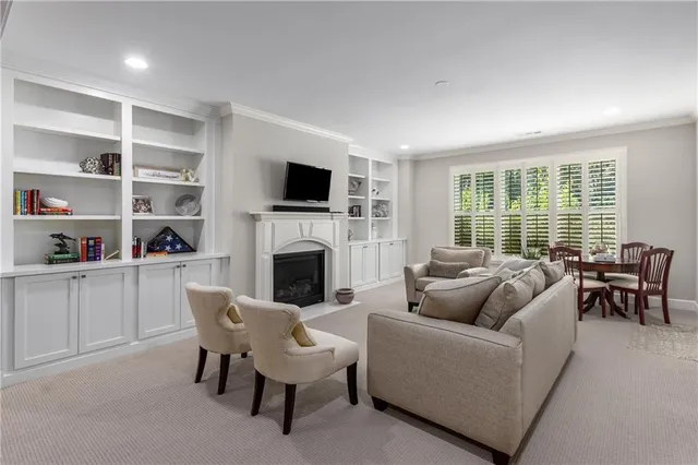a view of a house with a small yard plants and large tree