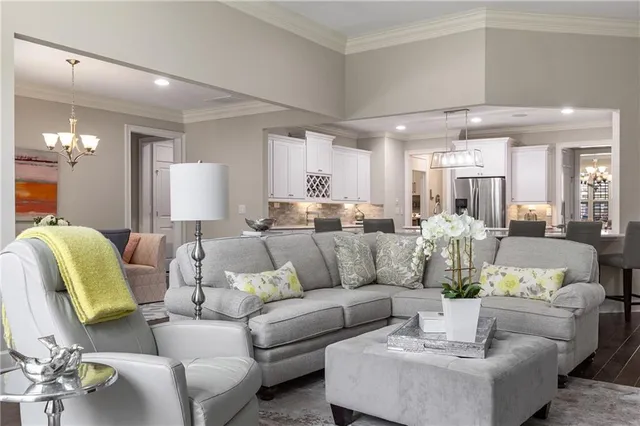 a kitchen with kitchen island granite countertop a sink and a stove top oven with wooden floor