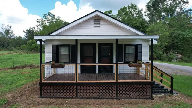 a view of a house with a chairs in patio