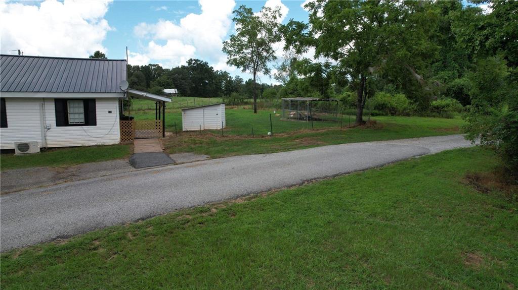930 Cantrell Road Marble Hill, GA 30148 - Photo 31 of 37 a view of a house with a yard and tree s