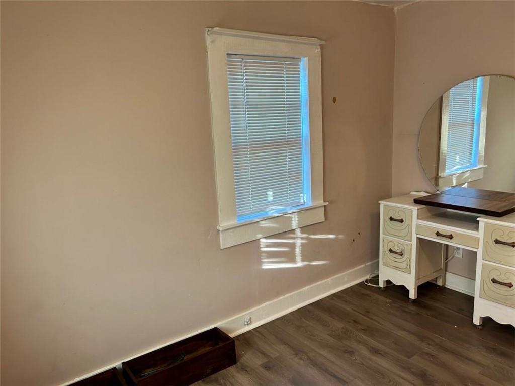 930 Cantrell Road Marble Hill, GA 30148 - Photo 7 of 37 a view of an empty room with a window and wooden floor