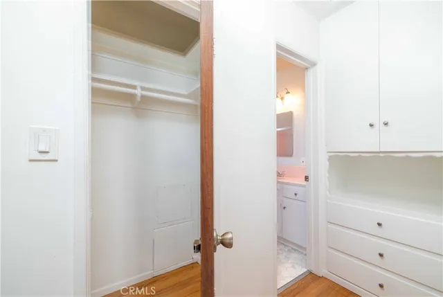a bathroom with a granite countertop toilet a sink and a mirror