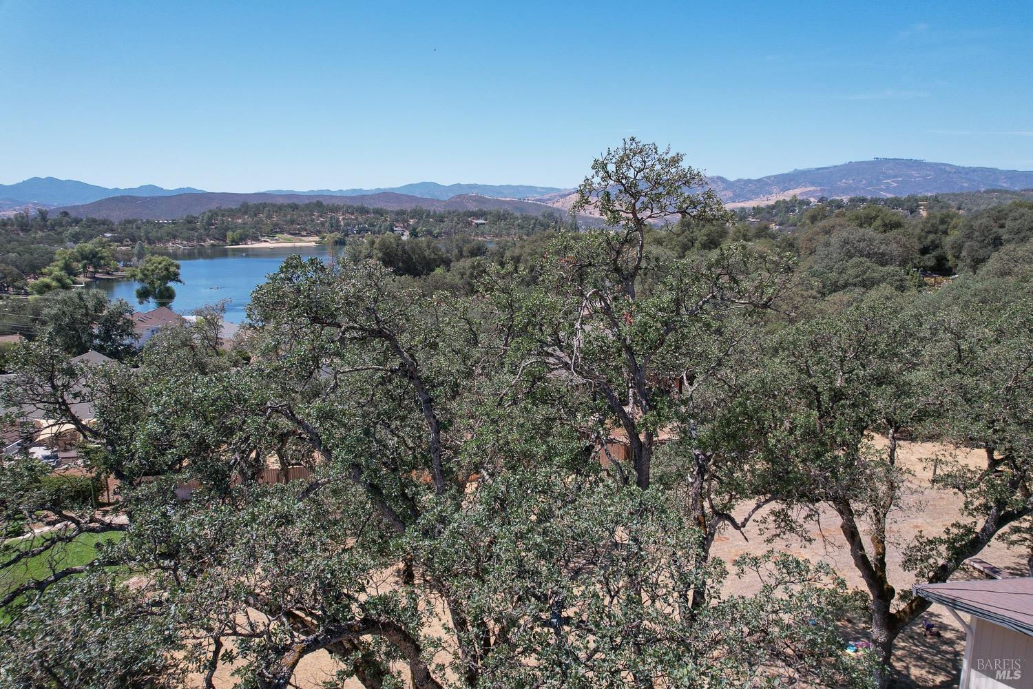 18903 Deer Hill Road Hidden Valley Lake, CA 95467 - Photo 12 of 32 An aerial view of the lake from over the vacant lot for sale.