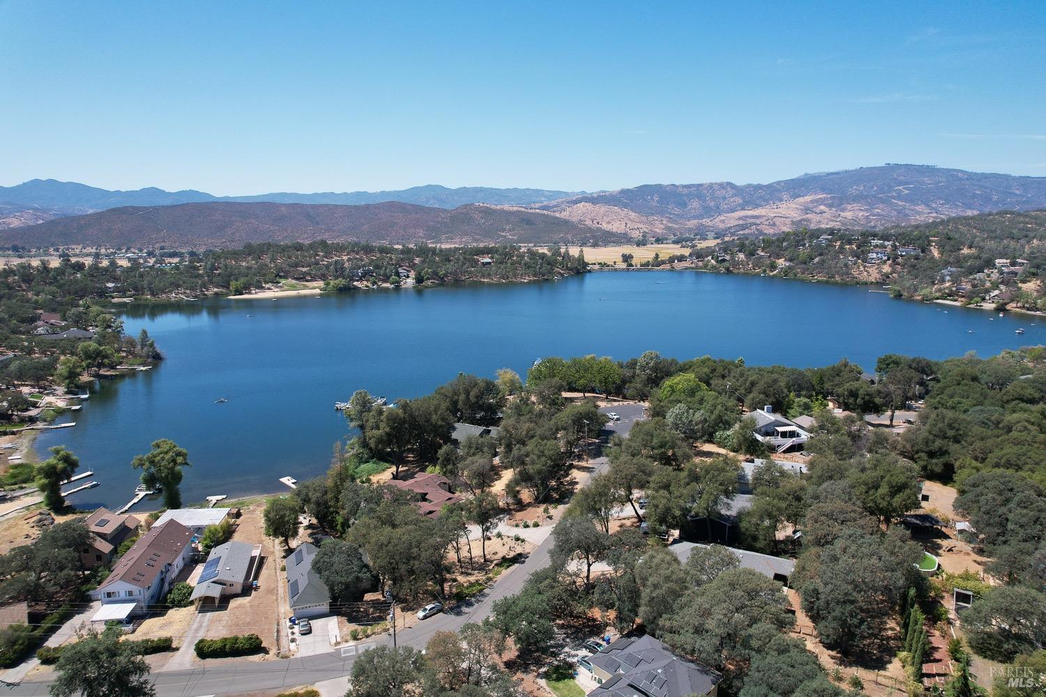 18903 Deer Hill Road Hidden Valley Lake, CA 95467 - Photo 2 of 32 An aerial view of Hidden Valley Lake, boasting102 surface acres of water with 2 manicured beaches, BBQ pits, picnic tables, playgrounds, volley ball court, 2 large dive rafts, boat dock and easy launch pads for paddle boarding and kayaking! This lot is located in the safe and secure gated community of Hidden Valley Lake.