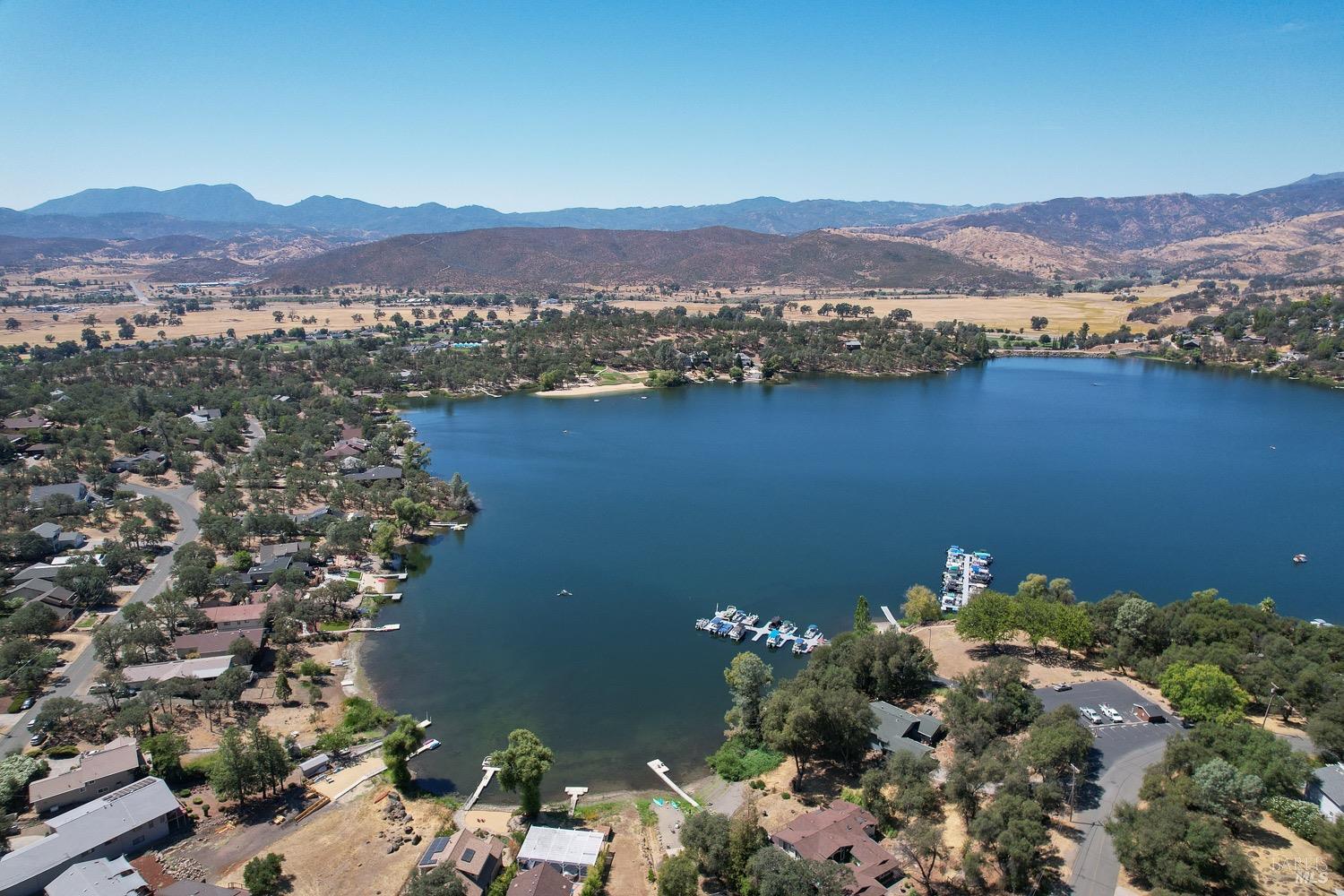 18903 Deer Hill Road Hidden Valley Lake, CA 95467 - Photo 8 of 32 An aerial view of Hidden Valley Lake, boasting102 surface acres of water with 2 manicured beaches, BBQ pits, picnic tables, playgrounds, volley ball court, 2 large dive rafts, boat dock and easy launch pads for paddle boarding and kayaking! This lot is located in the safe and secure gated community of Hidden Valley Lake.