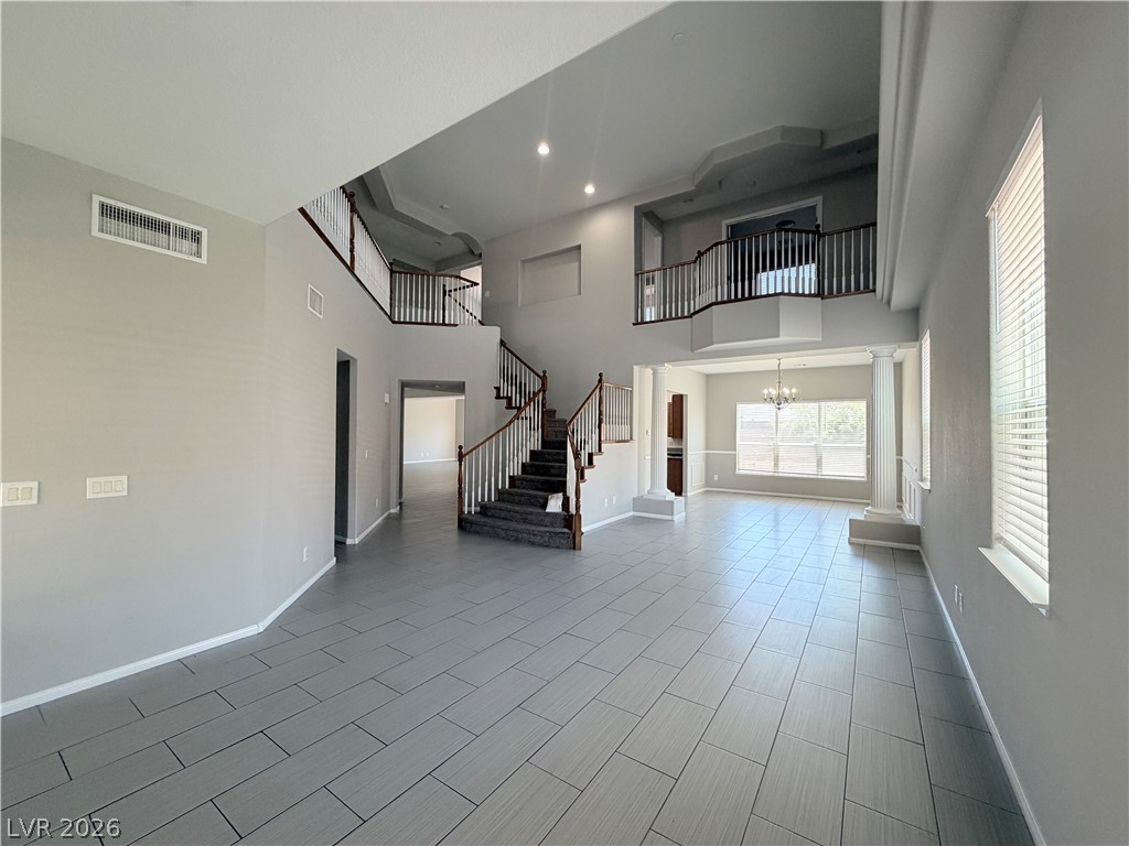 6116 Rabbit Track Street Las Vegas, NV 89130 - Photo 27 of 28 A grand entry with a double staircase and an open floor plan welcomes you inside.