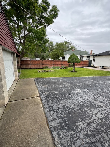 189 West Center Street Midvale, UT 84047 - Photo 61 of 64 Spacious yard featuring a manicured lawn and a privacy fence