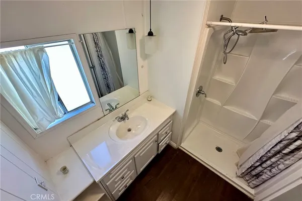 a bathroom with a sink a mirror and a shower
