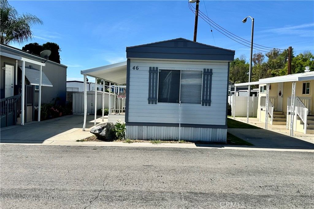 3825 Valley Boulevard, Unit 46 Walnut, CA 91789 - Photo 2 of 17 a front view of a house with a yard