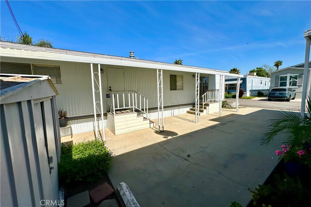 3825 Valley Boulevard, Unit 46 Walnut, CA 91789 - Photo 4 of 17 a view of a patio with table and chairs potted plants with wooden fence