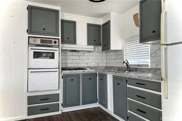 a kitchen with stainless steel appliances a stove and a refrigerator