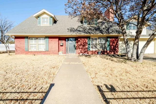 a view of a house with snow on the road