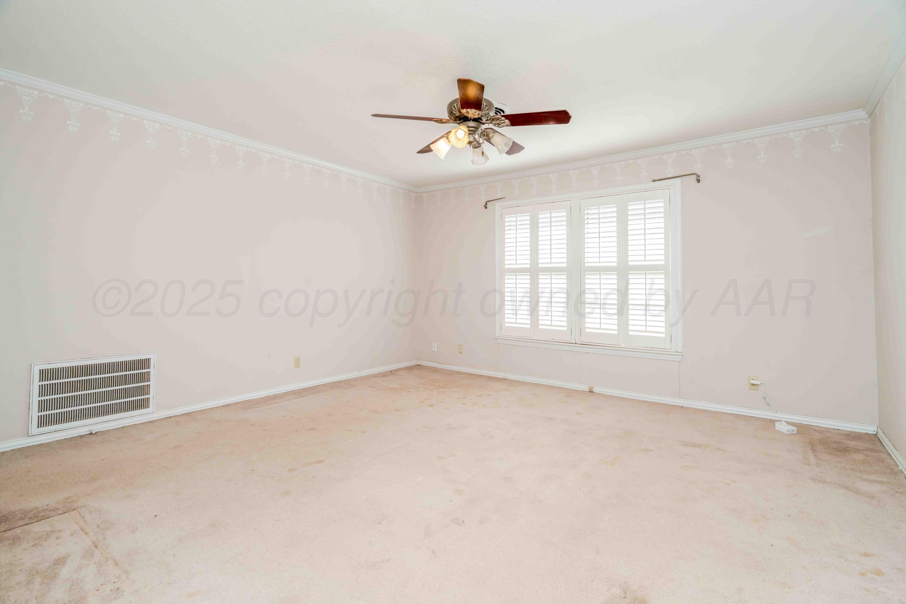 39 Crockett Drive Tulia, TX 79088 - Photo 18 of 29 wooden floor in an empty room with a window