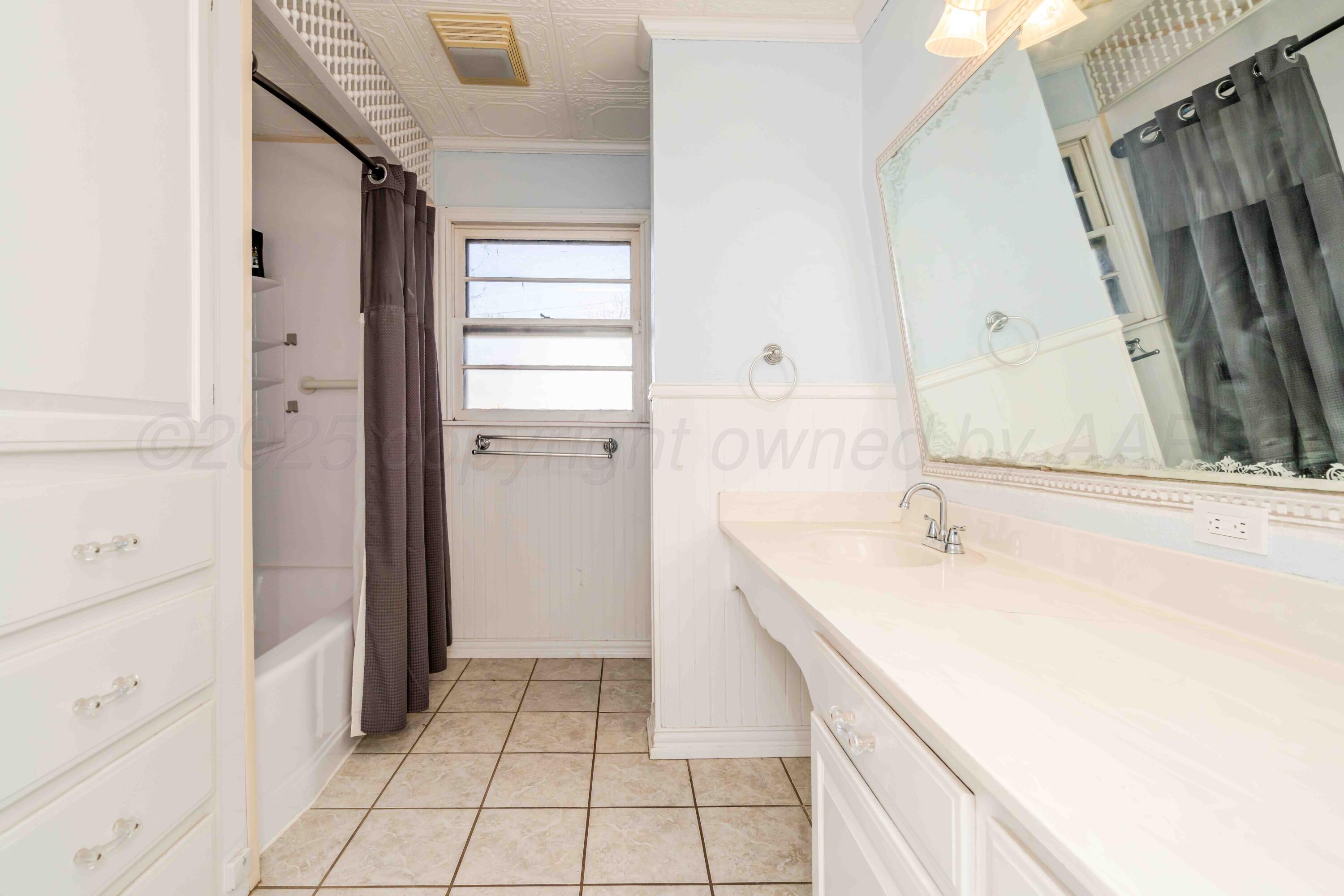 39 Crockett Drive Tulia, TX 79088 - Photo 20 of 29 a bathroom with a sink and a mirror