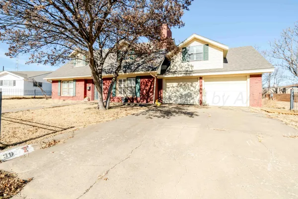 front view of a house with a snow in the yard