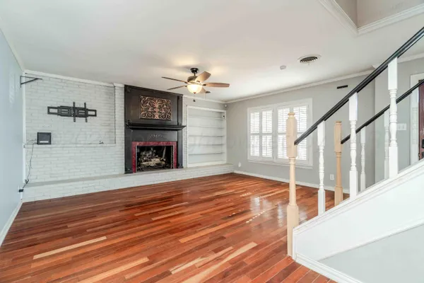 a living room with fireplace furniture and a wooden floor